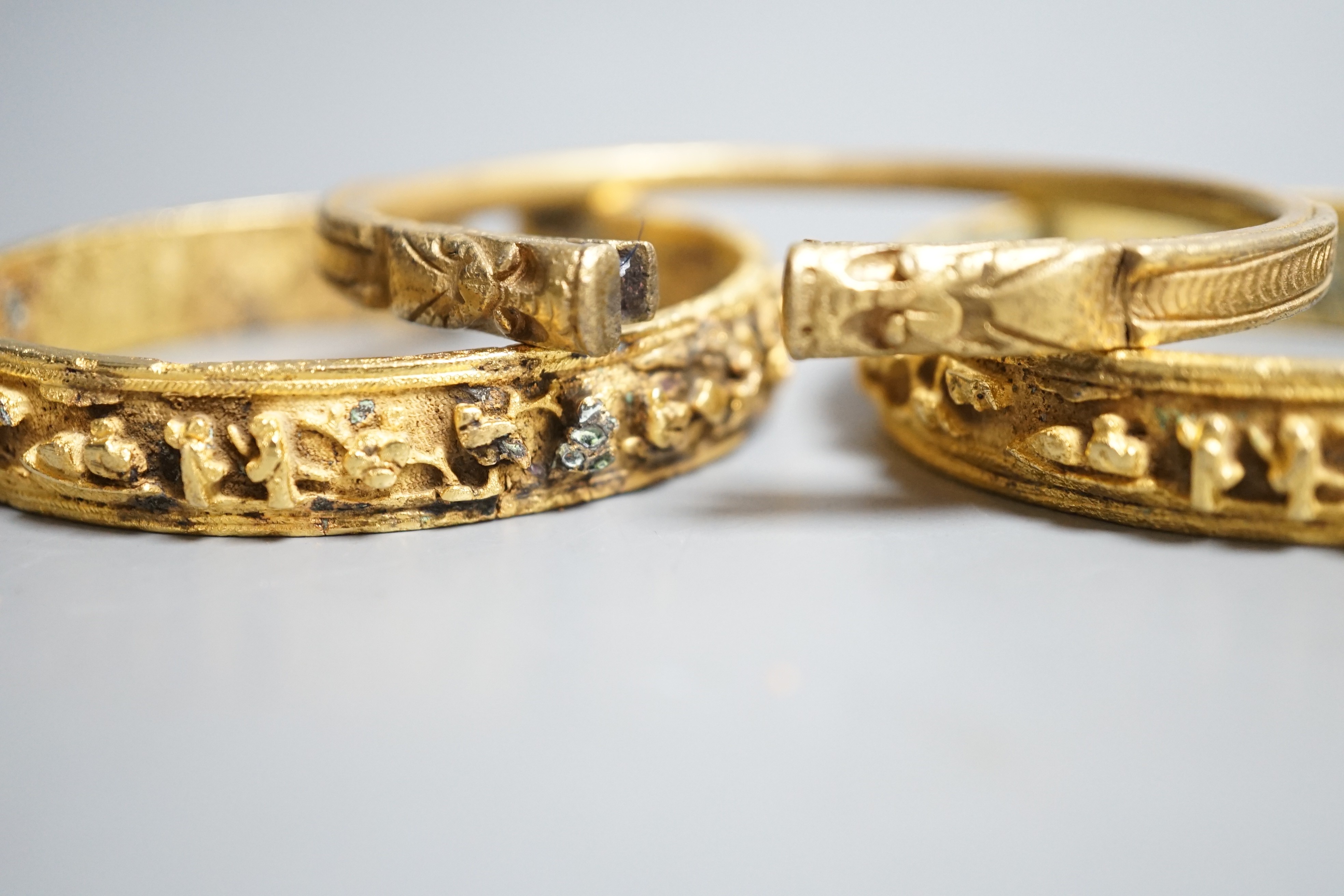 Three Chinese gilt bronze bangles, 19th/early 20th century